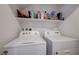 Bright laundry area with washer and dryer, includes storage space above at 1135 Tektite Ave, Henderson, NV 89011