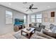 Bright and airy living room with large windows, a ceiling fan, and cozy furniture at 1135 Tektite Ave, Henderson, NV 89011