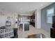 Open-concept living room showcasing modern kitchen, tile floors, and comfortable seating at 1135 Tektite Ave, Henderson, NV 89011