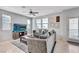 Comfortable living room with a ceiling fan, tile flooring, and large windows at 1135 Tektite Ave, Henderson, NV 89011