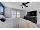 Inviting main bedroom featuring a cozy bed, ceiling fan, and ample natural light at 1135 Tektite Ave, Henderson, NV 89011