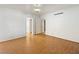 Spacious bedroom with hardwood floors, white walls, and classic lighting at 1139 5Th Pl, Las Vegas, NV 89104