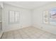 Bright bedroom with neutral walls, tile floors, and large windows with plantation shutters at 1139 5Th Pl, Las Vegas, NV 89104