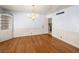 Dining room featuring hardwood floors, wainscoting, a chandelier, and built-in shelving at 1139 5Th Pl, Las Vegas, NV 89104