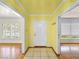 Welcoming entryway featuring yellow walls, tile flooring, and white trim, leading to various rooms at 1139 5Th Pl, Las Vegas, NV 89104