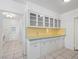 A well-lit kitchenette features white cabinets with glass doors and tile flooring at 1139 5Th Pl, Las Vegas, NV 89104