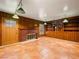 Living room with custom wood paneling, a brick fireplace, and tile flooring at 1139 5Th Pl, Las Vegas, NV 89104