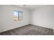 Cozy bedroom featuring carpet and large window with a view at 1660 Desert Path Ave, North Las Vegas, NV 89032