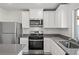 Stylish kitchen with stainless steel appliances, white cabinetry, and modern countertops at 1660 Desert Path Ave, North Las Vegas, NV 89032