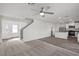 Open concept living space with hard surface floors, modern ceiling fan, and access to the kitchen at 1660 Desert Path Ave, North Las Vegas, NV 89032