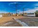 The property features a large empty back yard with a stone pathway and two utility poles at 1940 Walker St, Las Vegas, NV 89106
