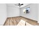 Cozy bedroom with wood-look flooring, a ceiling fan, and a sunlit window at 1940 Walker St, Las Vegas, NV 89106