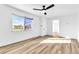 Inviting bedroom featuring wood-look flooring, a ceiling fan, and a bright window at 1940 Walker St, Las Vegas, NV 89106