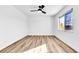 A serene bedroom featuring light wood flooring, a ceiling fan, and a bright window at 1940 Walker St, Las Vegas, NV 89106