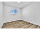 Bedroom with a window, white walls and trim, and wood-look floors at 1940 Walker St, Las Vegas, NV 89106