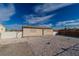 A single-story house with a clean exterior, decorative window coverings, and gravel landscaping at 1940 Walker St, Las Vegas, NV 89106