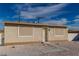 Close-up of a tidy single-story home with decorative window coverings, gravel landscaping, and a gated entry at 1940 Walker St, Las Vegas, NV 89106