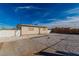 A home with a low profile sits on a lot with fresh gravel landscaping and a new wooden fence at 1940 Walker St, Las Vegas, NV 89106