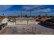 The house features a gravel front yard, a white fence, and a neutral exterior color palette at 1940 Walker St, Las Vegas, NV 89106