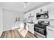 Beautiful kitchen with stainless steel appliances, white cabinets, and wood-look flooring at 1940 Walker St, Las Vegas, NV 89106
