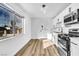 Bright kitchen featuring stainless steel appliances, white cabinets, wood-look flooring and a large window at 1940 Walker St, Las Vegas, NV 89106