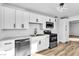 Contemporary kitchen featuring white cabinets, quartz countertops, and modern stainless steel appliances at 1940 Walker St, Las Vegas, NV 89106