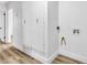 Bright laundry room features wood-look floors and white walls, as well as access to utilities and extra storage at 1940 Walker St, Las Vegas, NV 89106