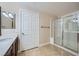Bright bathroom features walk-in shower with glass door, tiled floors, and ample counter space at 2100 Quarry Ridge St # 106, Las Vegas, NV 89117