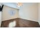 Bright bedroom features dark hardwood floors, ceiling fan, and a window with blinds at 2100 Quarry Ridge St # 106, Las Vegas, NV 89117