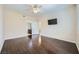 Spacious bedroom with hardwood floors and mounted TV, conveniently located near the bathroom at 2100 Quarry Ridge St # 106, Las Vegas, NV 89117