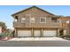 Apartment complex featuring multiple garages, staircases, and covered patios at 2100 Quarry Ridge St # 106, Las Vegas, NV 89117