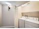 Convenient laundry room with washer, dryer, and overhead lighting at 2100 Quarry Ridge St # 106, Las Vegas, NV 89117