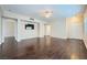 Open living area with hardwood floors, ceiling fan, and TV, perfect for relaxing at 2100 Quarry Ridge St # 106, Las Vegas, NV 89117