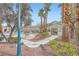 Community pool area with lounge chairs, gazebo, palm trees, and garden at 2100 Quarry Ridge St # 106, Las Vegas, NV 89117