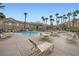 Resort-style pool with ample seating, mature palm trees, and building views at 2100 Quarry Ridge St # 106, Las Vegas, NV 89117