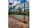 Outdoor tennis court with green chain-link fence, trees, and building view at 2100 Quarry Ridge St # 106, Las Vegas, NV 89117