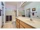 Clean bathroom with shower, neutral tile, and wood vanity, offering a functional and well-lit space at 2152 Mountain City St, Henderson, NV 89052