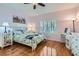 Cozy bedroom with hardwood floors, light pink walls, bright natural light, and ceiling fan at 2152 Mountain City St, Henderson, NV 89052