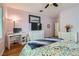 Bedroom with wooden floors, light pink walls, white furnishings, and a ceiling fan at 2152 Mountain City St, Henderson, NV 89052