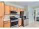 Efficient kitchen layout featuring wood cabinets, stainless steel appliances, and tile flooring at 2152 Mountain City St, Henderson, NV 89052