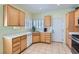 Well-lit kitchen with wood cabinets, a corner window, and tile flooring at 2152 Mountain City St, Henderson, NV 89052