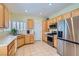 Functional kitchen featuring wood cabinets, modern appliances, and tile floors at 2152 Mountain City St, Henderson, NV 89052
