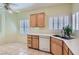 Bright kitchen featuring wood cabinets, double sink, and shuttered windows for natural light at 2152 Mountain City St, Henderson, NV 89052