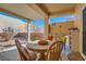 Charming patio featuring a round wooden table, comfortable seating, and a tranquil outdoor space at 2152 Mountain City St, Henderson, NV 89052