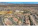 Photo showing the aerial view of a residential neighborhood with athletic fields and city views at 2345 Gondi Castle Ave, Henderson, NV 89044
