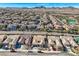 Stunning aerial view of a neighborhood featuring well-maintained homes, desert landscaping, and mountain views at 2345 Gondi Castle Ave, Henderson, NV 89044