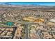 Aerial view of a community with tennis courts and baseball fields surrounded by attractive residential homes at 2345 Gondi Castle Ave, Henderson, NV 89044