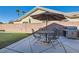 Outdoor patio with a built-in BBQ, seating area, and an adjacent putting green for leisure and entertainment at 2345 Gondi Castle Ave, Henderson, NV 89044