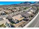Aerial view of a private backyard with desert landscaping, a covered patio, and a brick perimeter fence at 2345 Gondi Castle Ave, Henderson, NV 89044