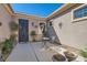 Cozy front patio with a small seating area and mature landscaping around the entrance at 2345 Gondi Castle Ave, Henderson, NV 89044